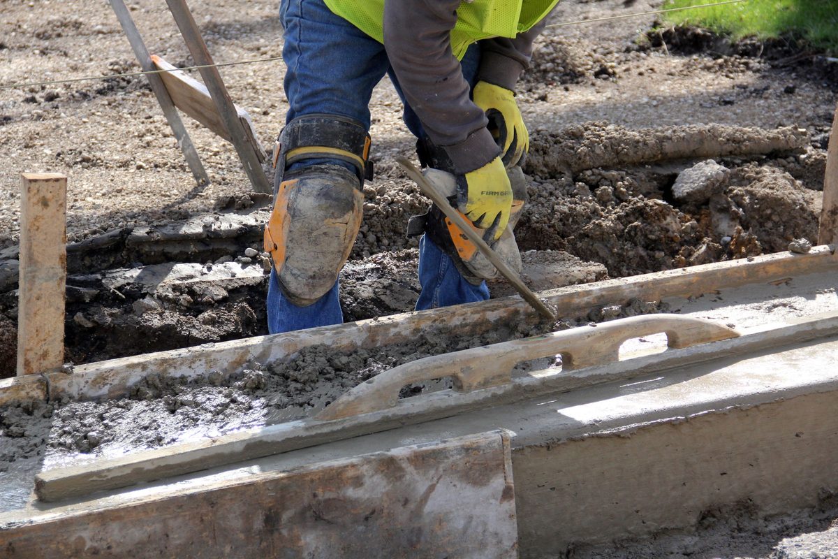 Hand trowel finishing a fresh concrete surface