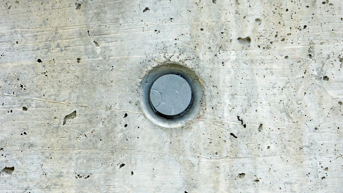 A clean core-drilled penetration through a concrete wall