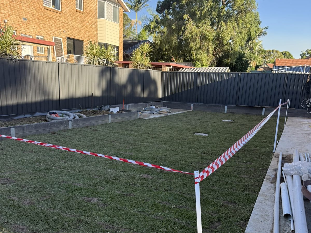 Colorbond boundary fence running the length of a residential backyard